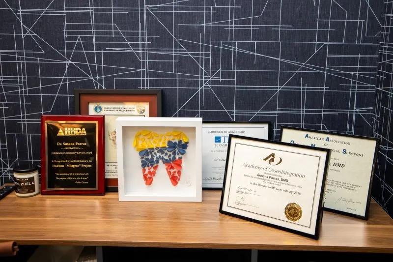 desk with framed awards from Dr. Porras